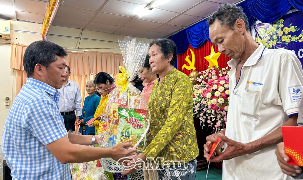 Ông Hồ Song Toàn, Phó chủ tịch UBND huyện Trần Văn Thời, trao quà cho hộ nghèo.