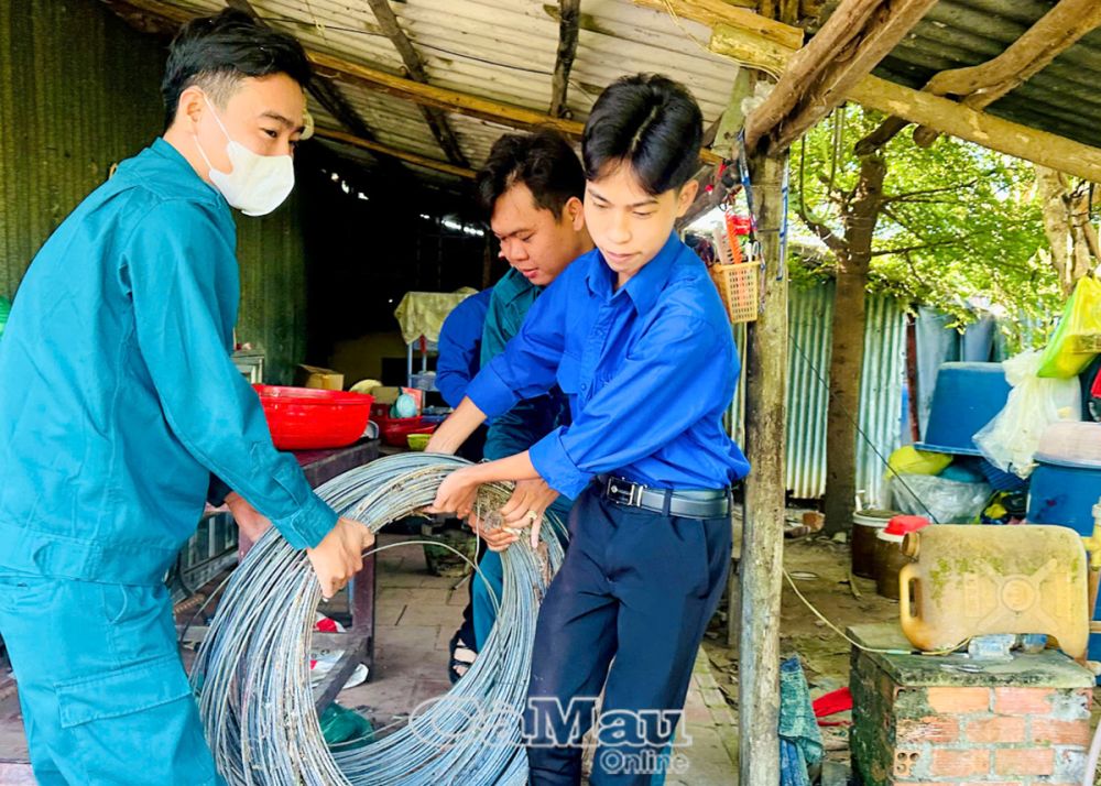 Tại huyện Thới Bình, ÐVTN nhiệt tình phụ các hộ dân di dời đồ đạc ra khỏi nhà cũ để xây nhà mới.